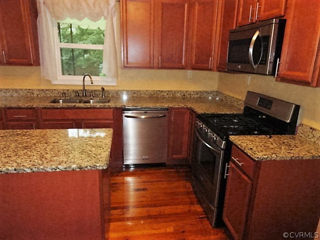 2100 Springdale Road Richmond, VA 23222 - Photo 9 of 28 a kitchen with granite countertop a stove a sink and a microwave