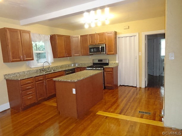 2100 Springdale Road Richmond, VA 23222 - Photo 10 of 28 a kitchen with stainless steel appliances granite countertop a stove a sink and a refrigerator