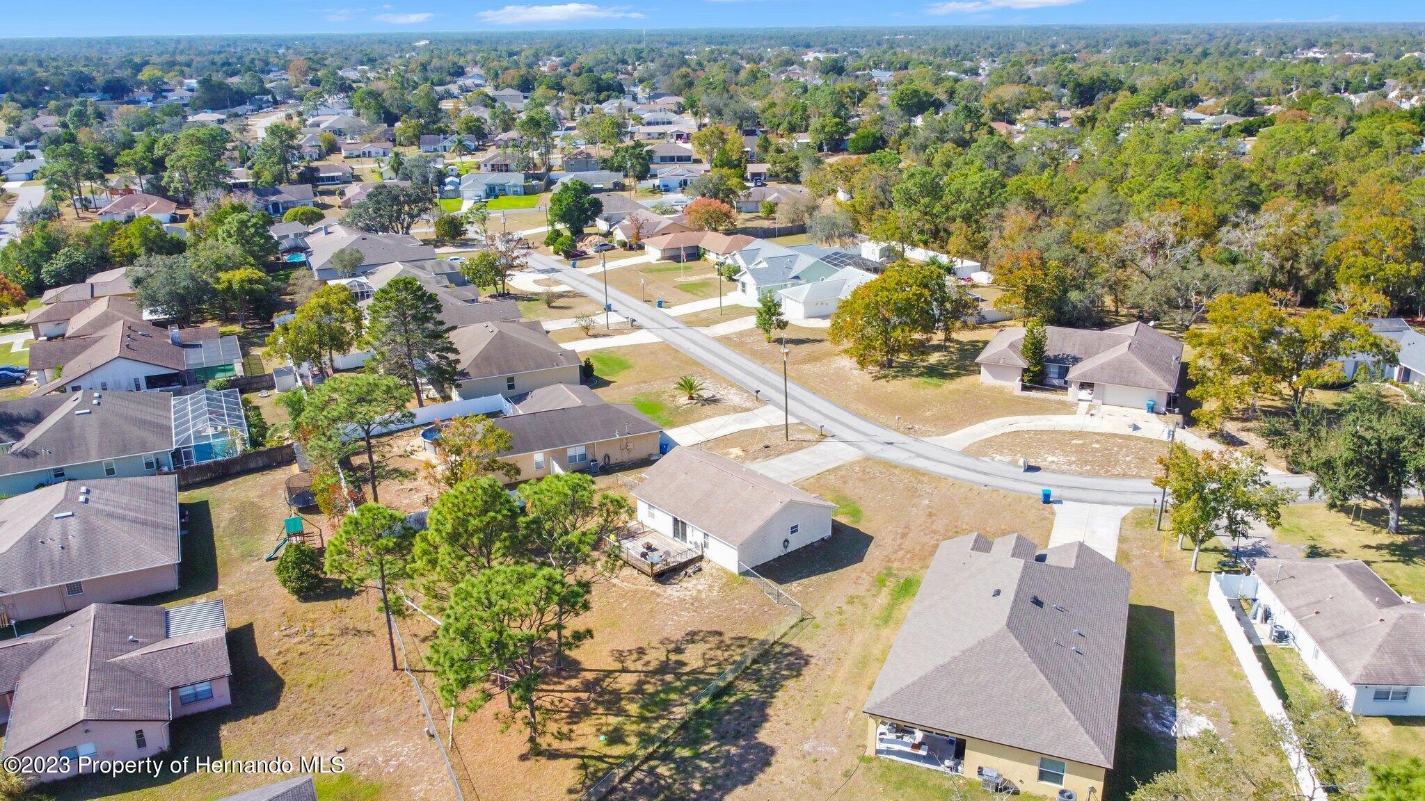 4422 Dior Road Spring Hill, FL 34609 - Photo 8 of 39 an aerial view of residential houses with outdoor space