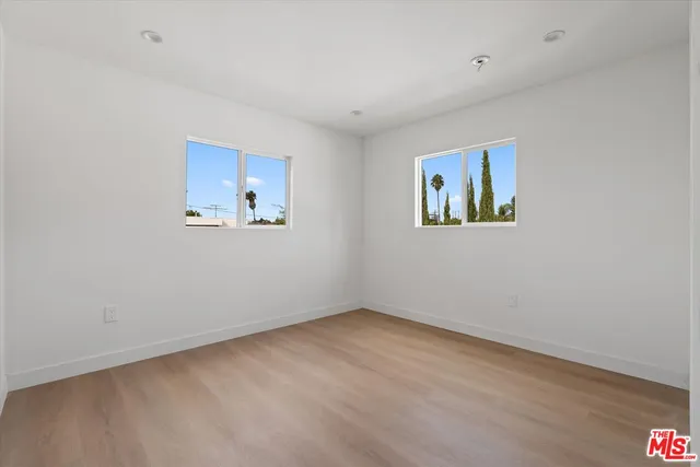 a view of an empty room with a painting on the wall