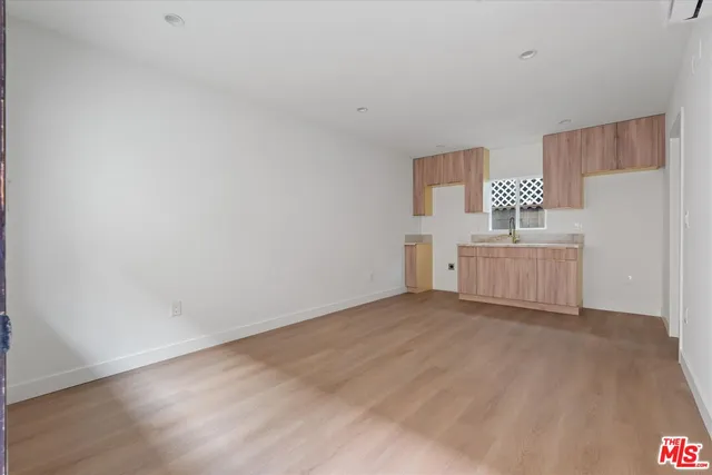 a view of a room with wooden floor and a cabinet
