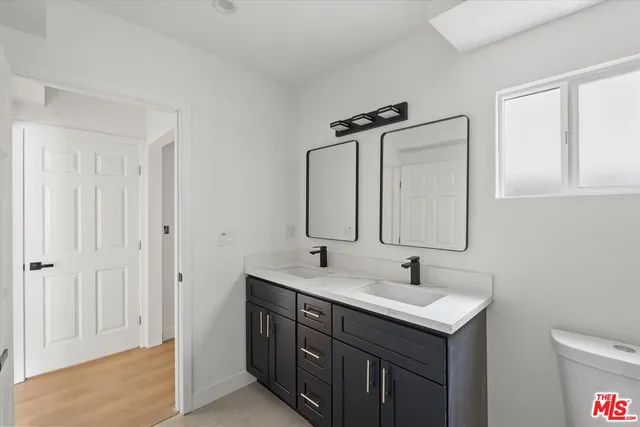 a bathroom with 2 sink and a mirror