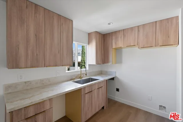 a kitchen with a sink cabinets and window
