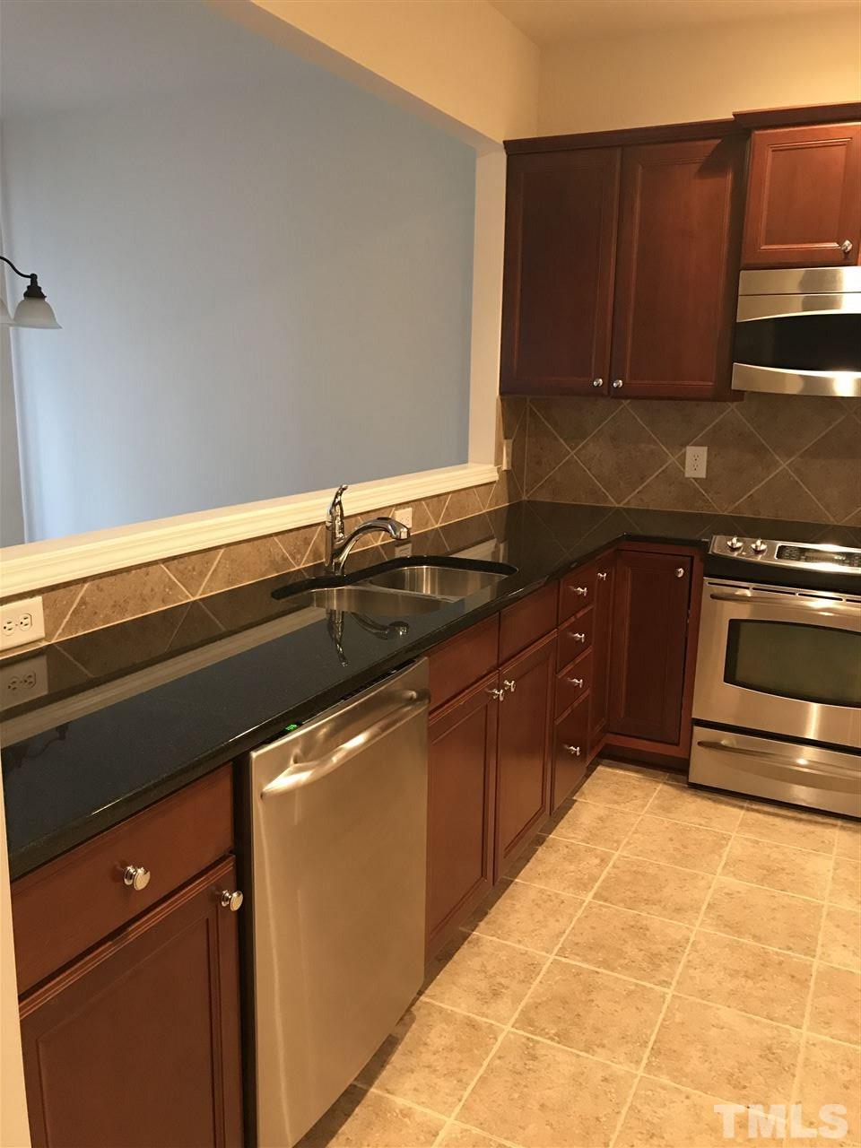 8213 Saltwood Place Raleigh, NC 27617 - Photo 2 of 13 a kitchen with a sink and cabinets