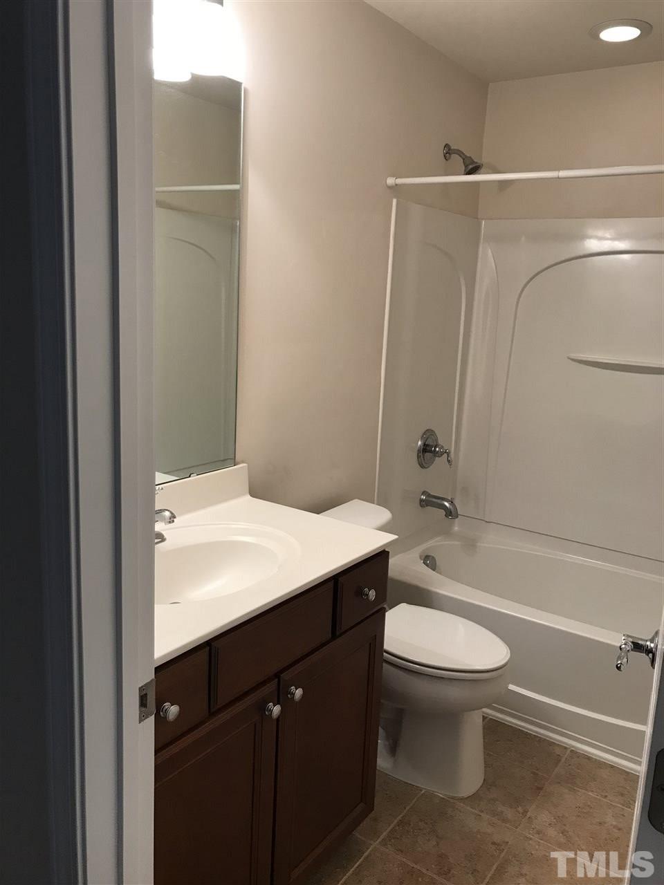 8213 Saltwood Place Raleigh, NC 27617 - Photo 11 of 13 a bathroom with a sink a toilet and shower