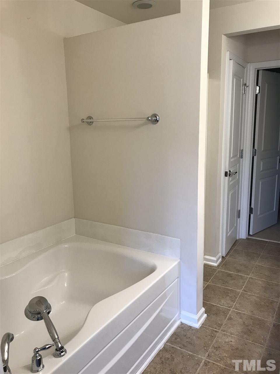 8213 Saltwood Place Raleigh, NC 27617 - Photo 12 of 13 a bathroom with a tub