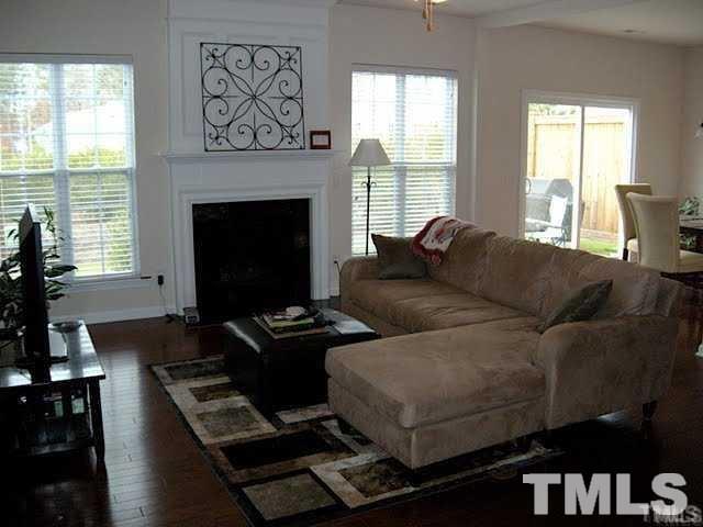 8213 Saltwood Place Raleigh, NC 27617 - Photo 4 of 13 a living room with furniture window and a fireplace