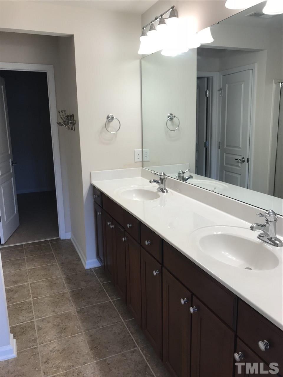 8213 Saltwood Place Raleigh, NC 27617 - Photo 8 of 13 a bathroom with a double vanity sink and mirror