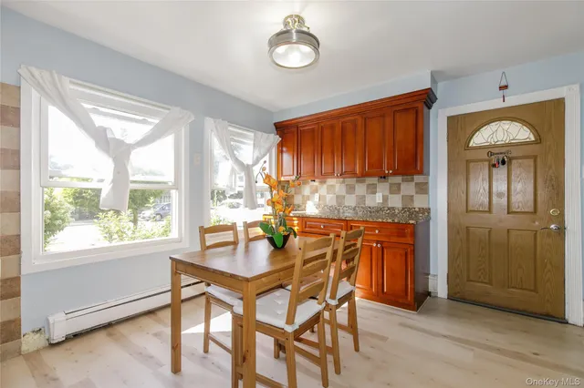 a dining room with furniture and window