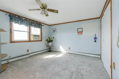 a bathroom with a granite countertop sink a toilet and a shower