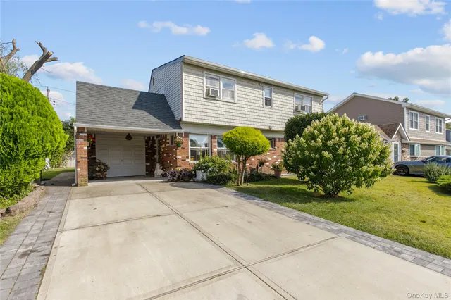 a front view of a house with garden and plants