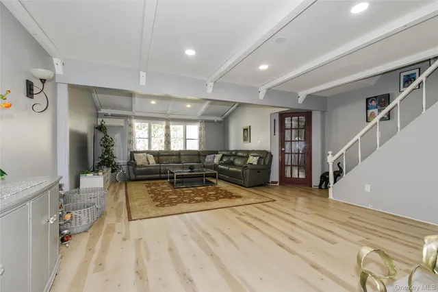 a living room with furniture a table and chairs