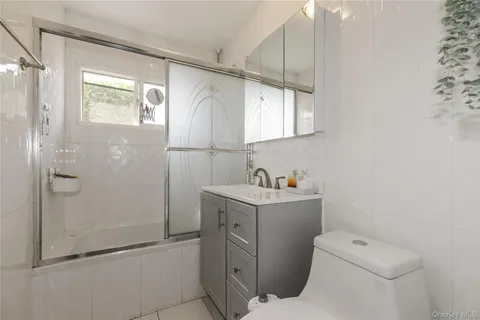 a bathroom with a toilet sink and shower