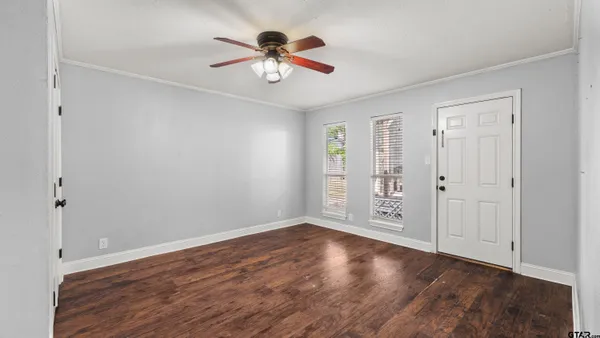 wooden floor in an empty room with a window