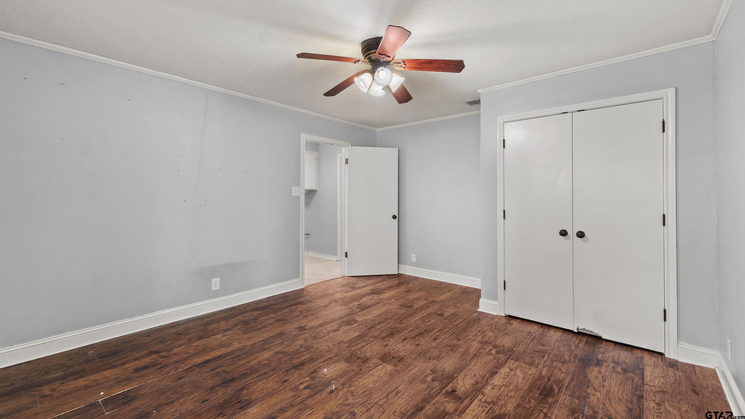3418 Main Street Texarkana, TX 75503 - Photo 12 of 28 a view of room with hardwood floor and a ceiling fan