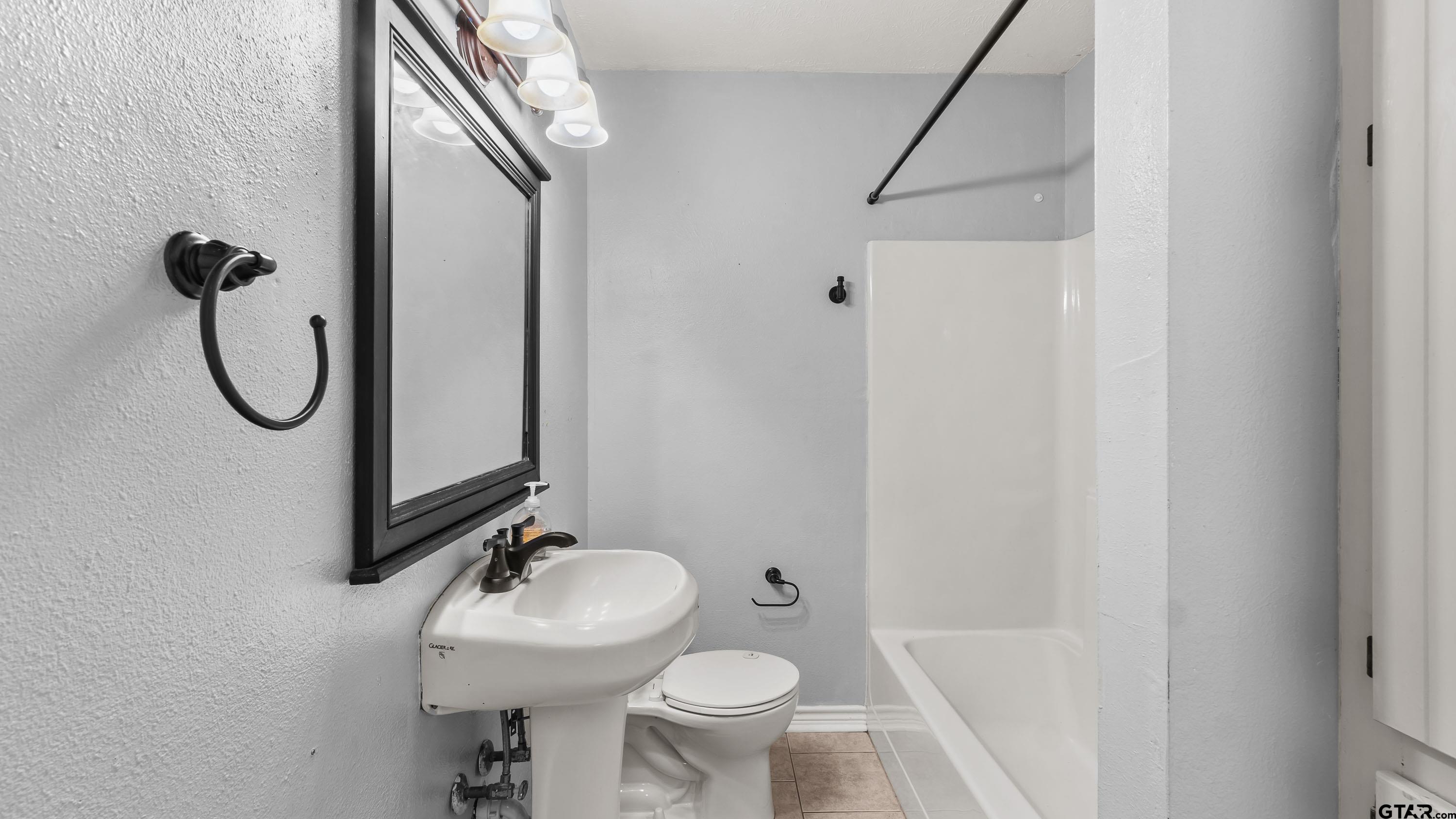 3418 Main Street Texarkana, TX 75503 - Photo 13 of 28 a bathroom with a sink toilet and shower
