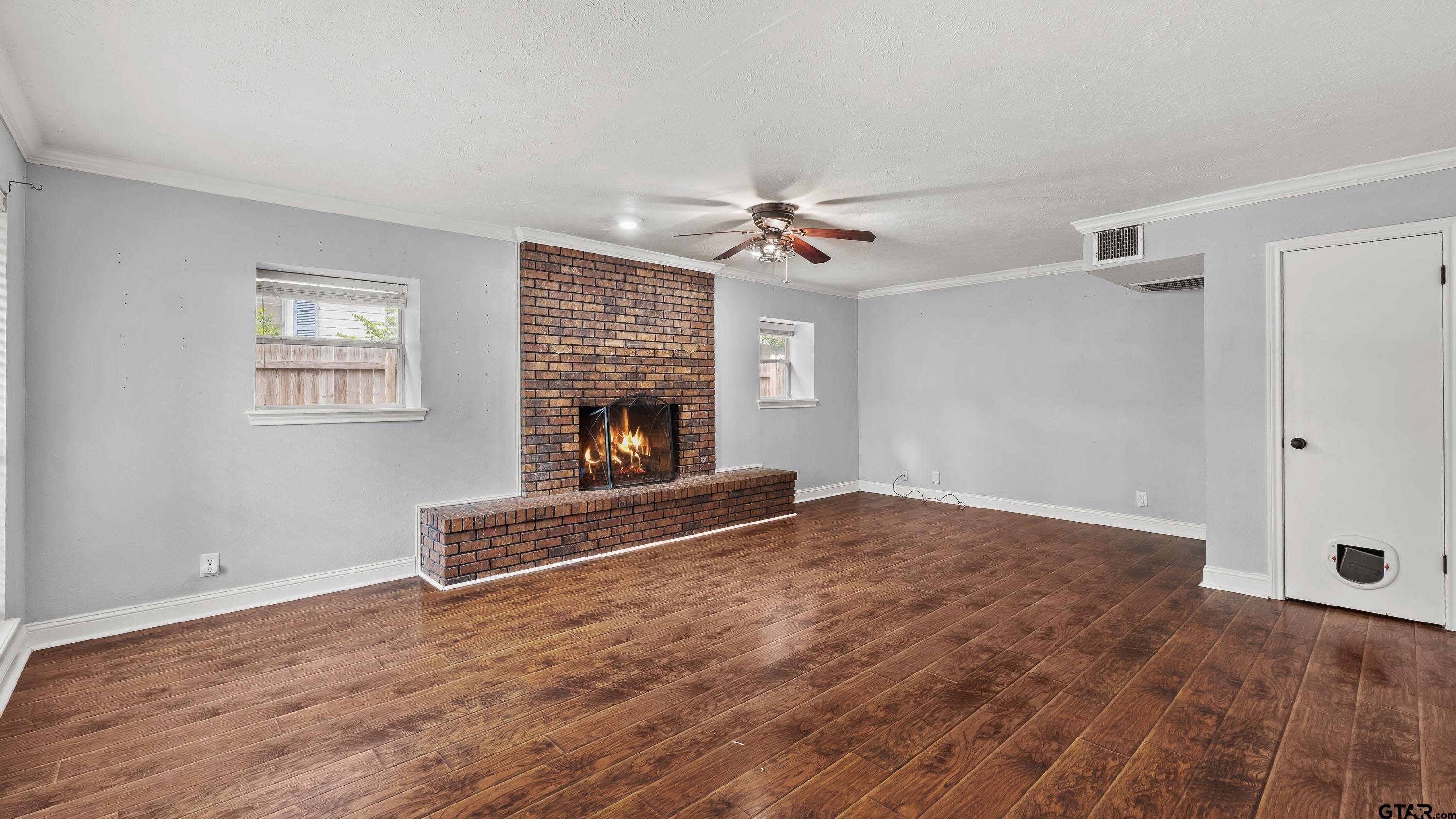 3418 Main Street Texarkana, TX 75503 - Photo 4 of 28 a view of empty room with fireplace and wooden floor