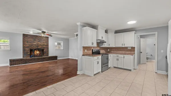 a kitchen with white cabinets and appliances