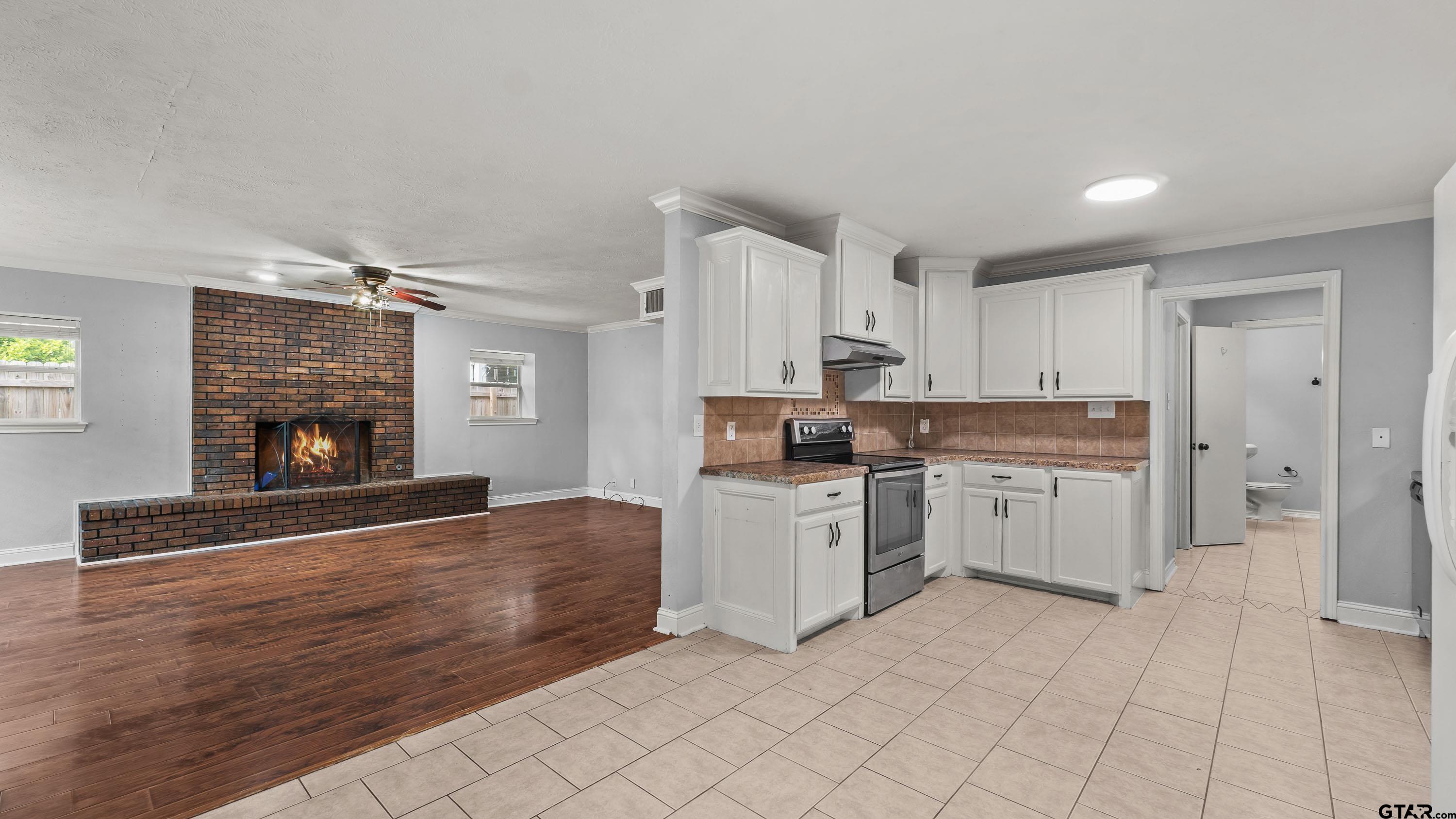 3418 Main Street Texarkana, TX 75503 - Photo 5 of 28 a kitchen with white cabinets and appliances