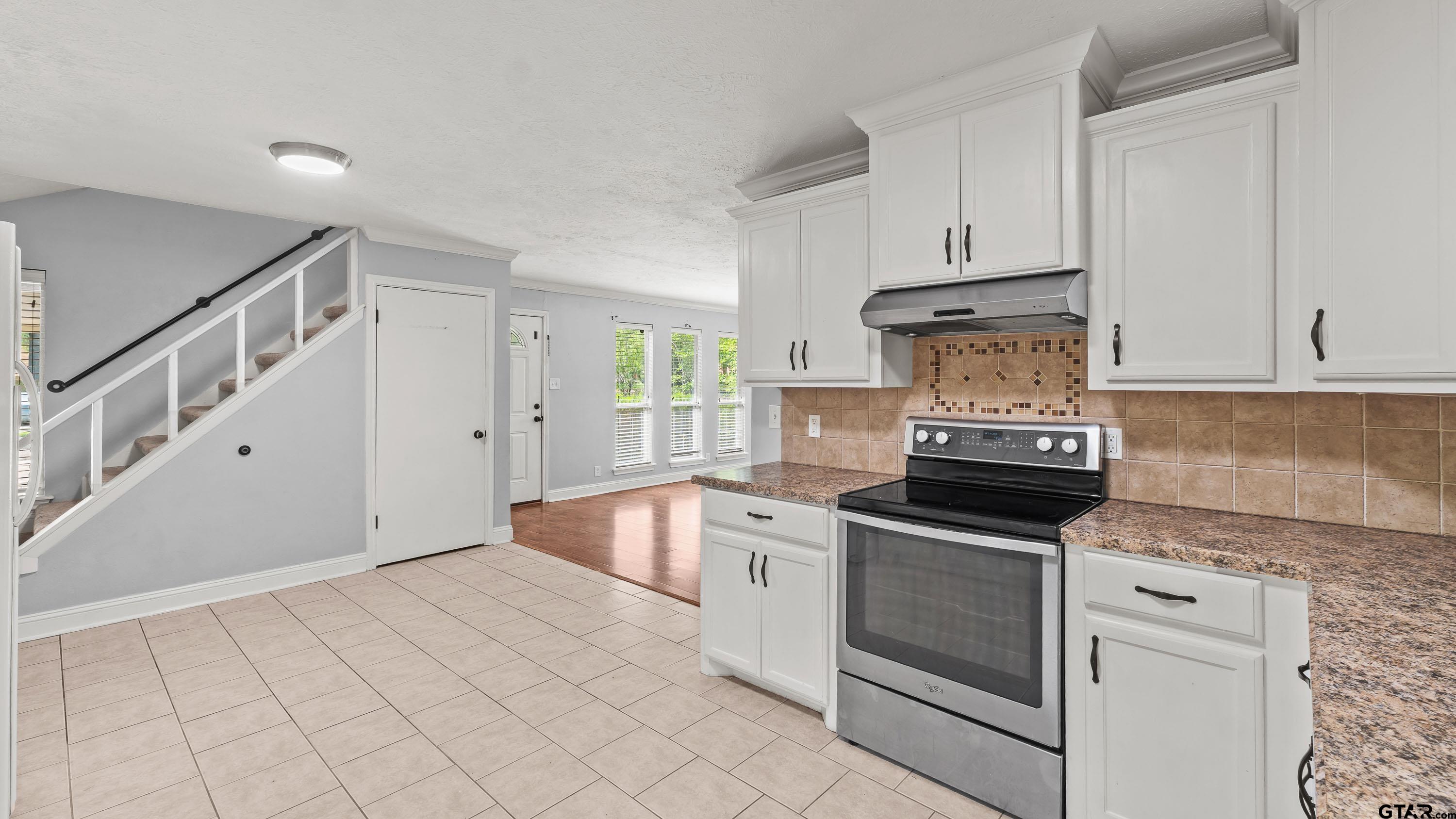 3418 Main Street Texarkana, TX 75503 - Photo 9 of 28 a kitchen with granite countertop white cabinets and white appliances
