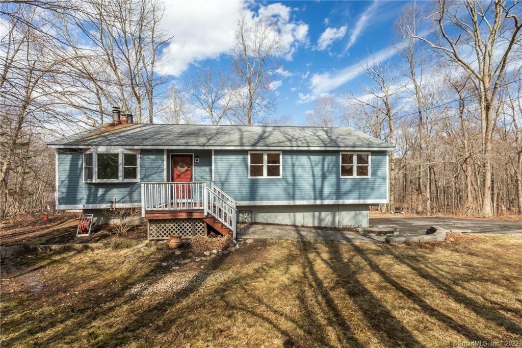 a view of a house with a yard covered in snow
