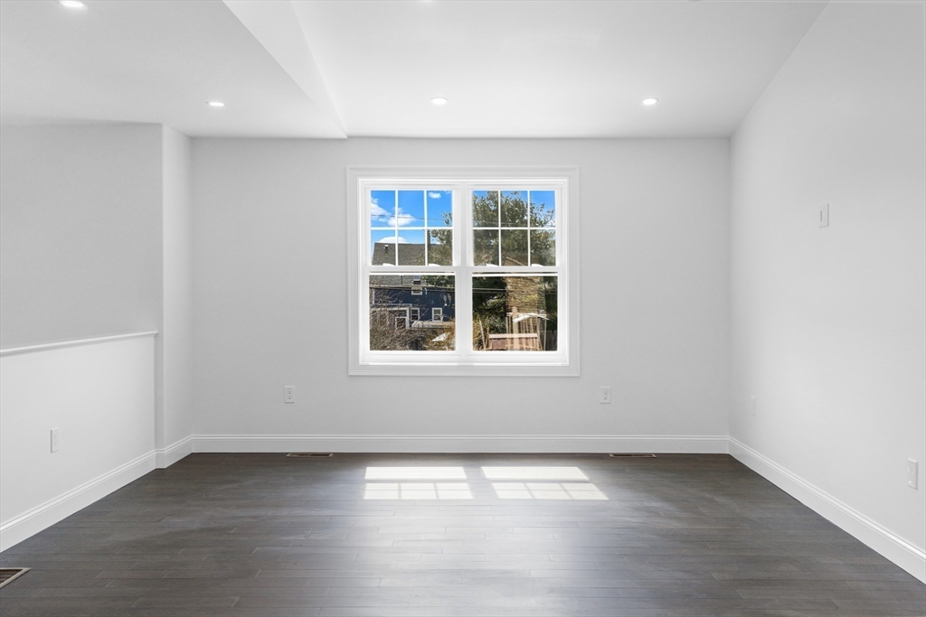 15 Jean Street Acushnet, MA 02743 - Photo 14 of 42 an empty room with wooden floor and windows