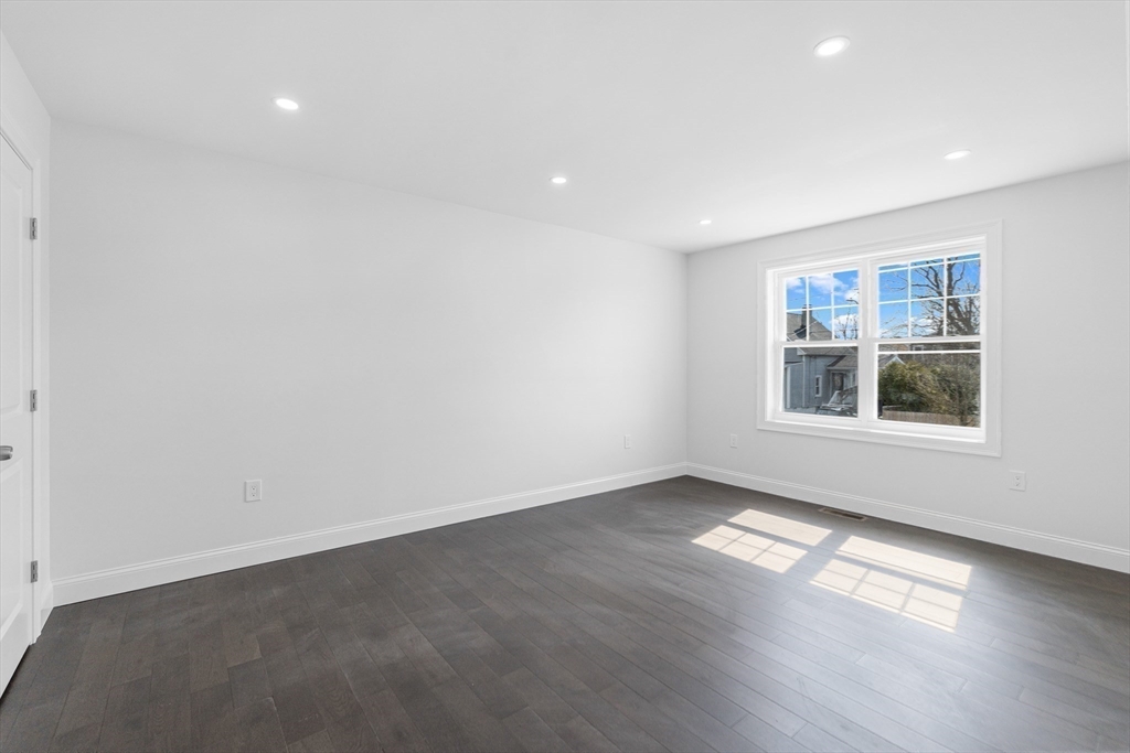 15 Jean Street Acushnet, MA 02743 - Photo 15 of 42 a view of an empty room with a window and wooden floor