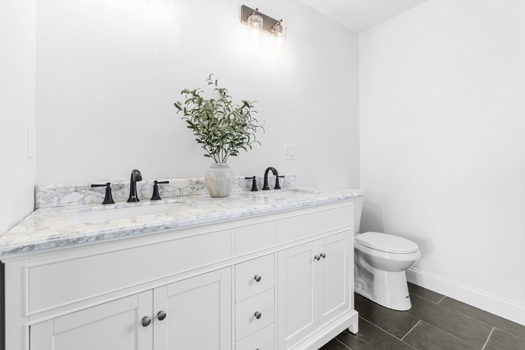 15 Jean Street Acushnet, MA 02743 - Photo 19 of 42 a bathroom with a granite countertop sink and a toilet