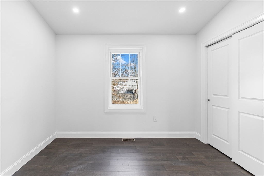 15 Jean Street Acushnet, MA 02743 - Photo 27 of 42 an empty room with wooden floor and windows