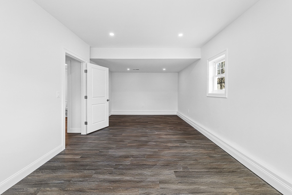 15 Jean Street Acushnet, MA 02743 - Photo 32 of 42 a view of an empty room with wooden floor and windows