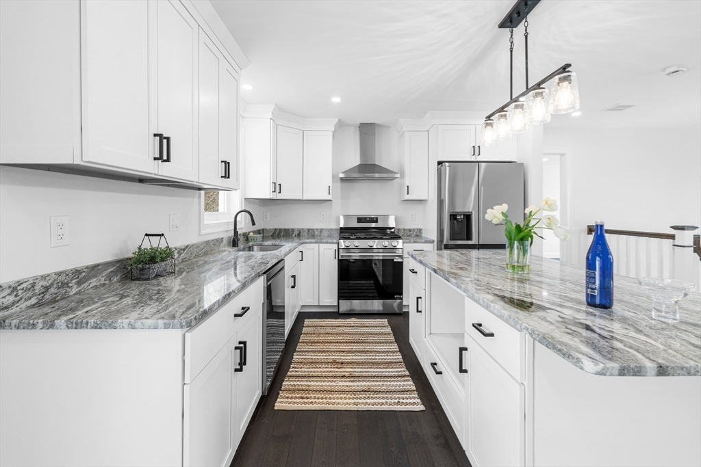 15 Jean Street Acushnet, MA 02743 - Photo 8 of 42 a kitchen with stainless steel appliances granite countertop a sink counter space cabinets and a large window