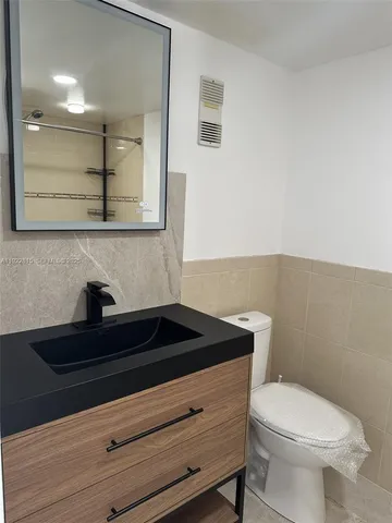 a view of room with a ceiling fan and window