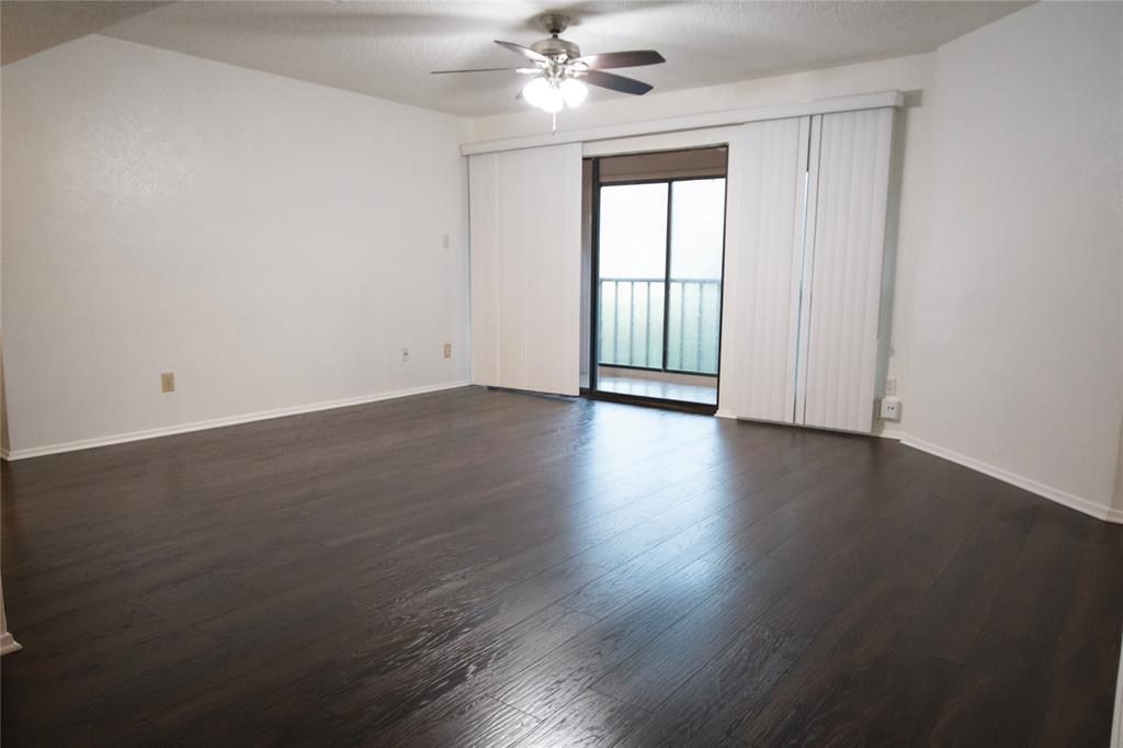 11460 Audelia Road, Unit 272 Dallas, TX 75243 - Photo 11 of 27 an empty room with wooden floor fan and windows