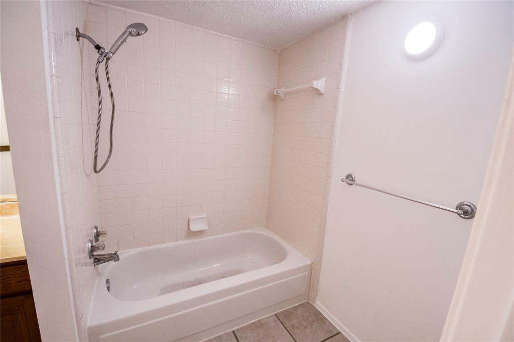 11460 Audelia Road, Unit 272 Dallas, TX 75243 - Photo 14 of 27 a bathroom with a bathtub and a shower