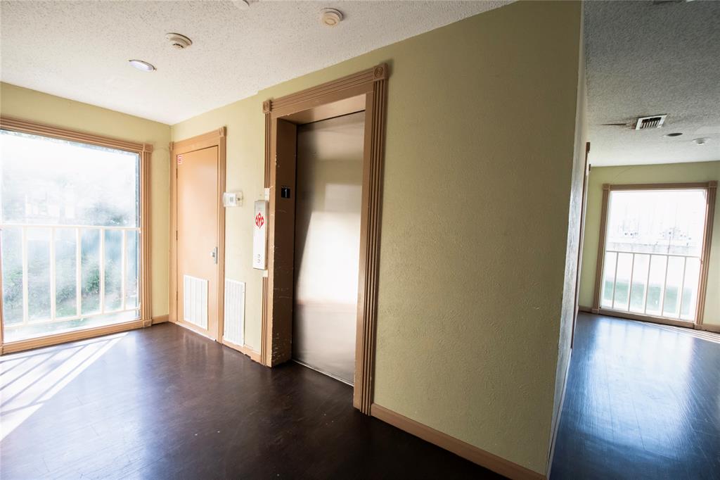 11460 Audelia Road, Unit 272 Dallas, TX 75243 - Photo 19 of 27 a view of an empty room with wooden floor and a window