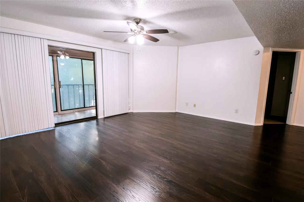 11460 Audelia Road, Unit 272 Dallas, TX 75243 - Photo 8 of 27 wooden floor in an empty room with a window