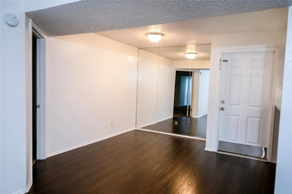 11460 Audelia Road, Unit 272 Dallas, TX 75243 - Photo 9 of 27 an empty room with wooden floor and windows