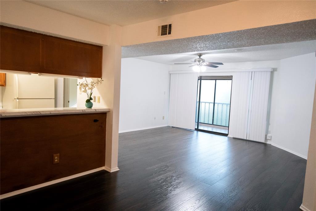 11460 Audelia Road, Unit 272 Dallas, TX 75243 - Photo 10 of 27 an empty room with wooden floor and windows