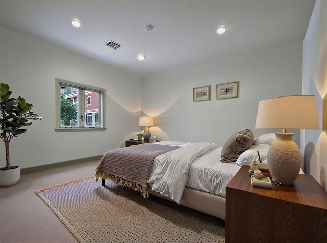 a bedroom with a bed and a painting on the wall