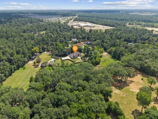 an aerial view of a house with a yard