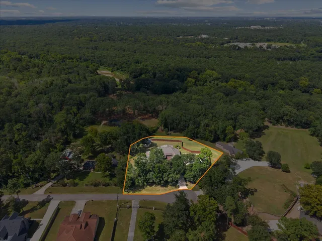 an aerial view of a house with a yard