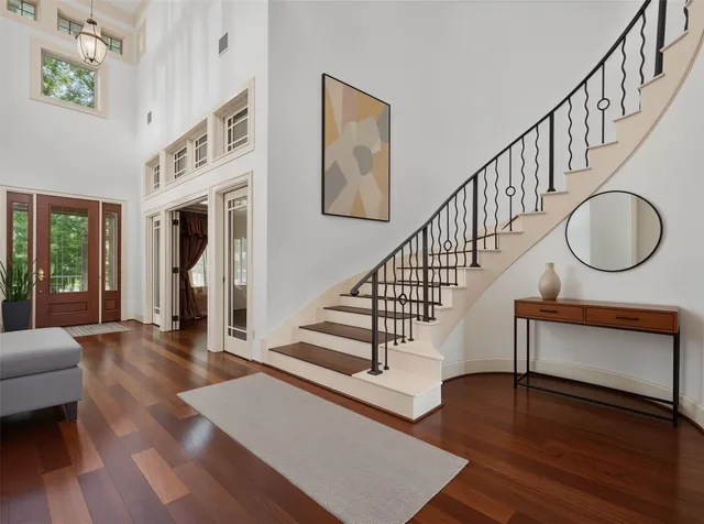 a view of staircase with wooden floor and a rug