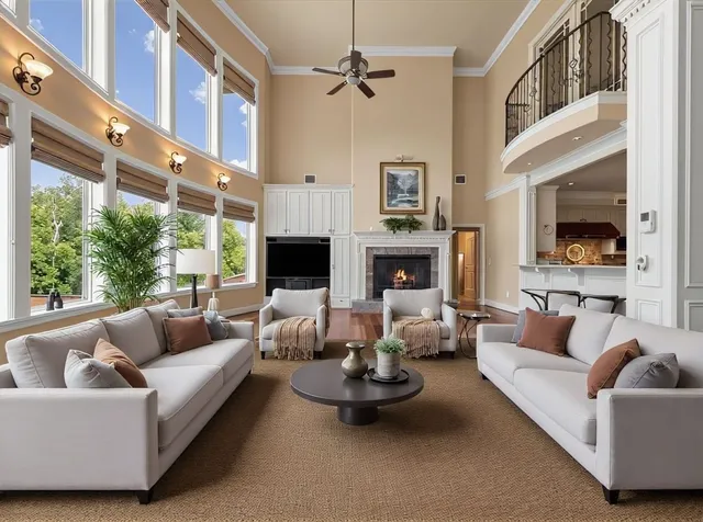 a living room with furniture fireplace and a large window