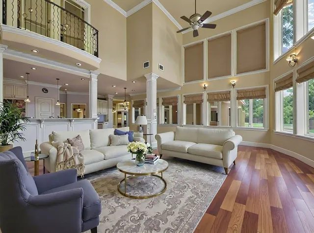 a living room with furniture and wooden floor