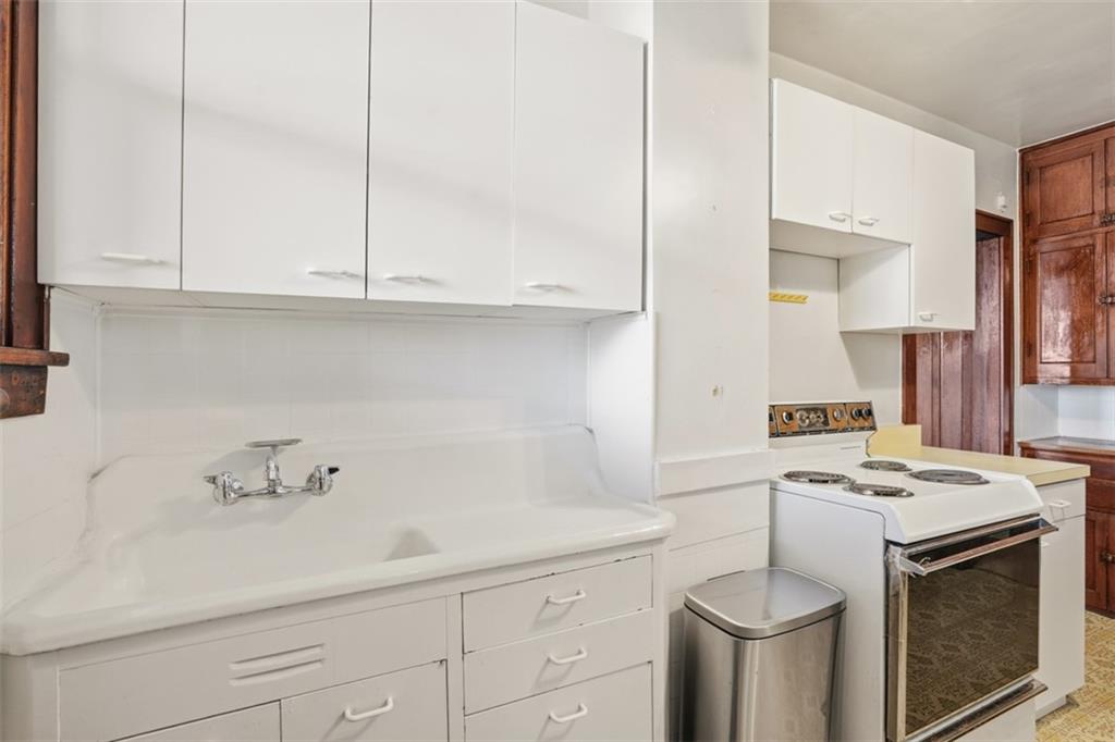 205 Clover Street Pittsburgh, PA 15210 - Photo 19 of 49 a kitchen with stainless steel appliances white cabinets and a sink