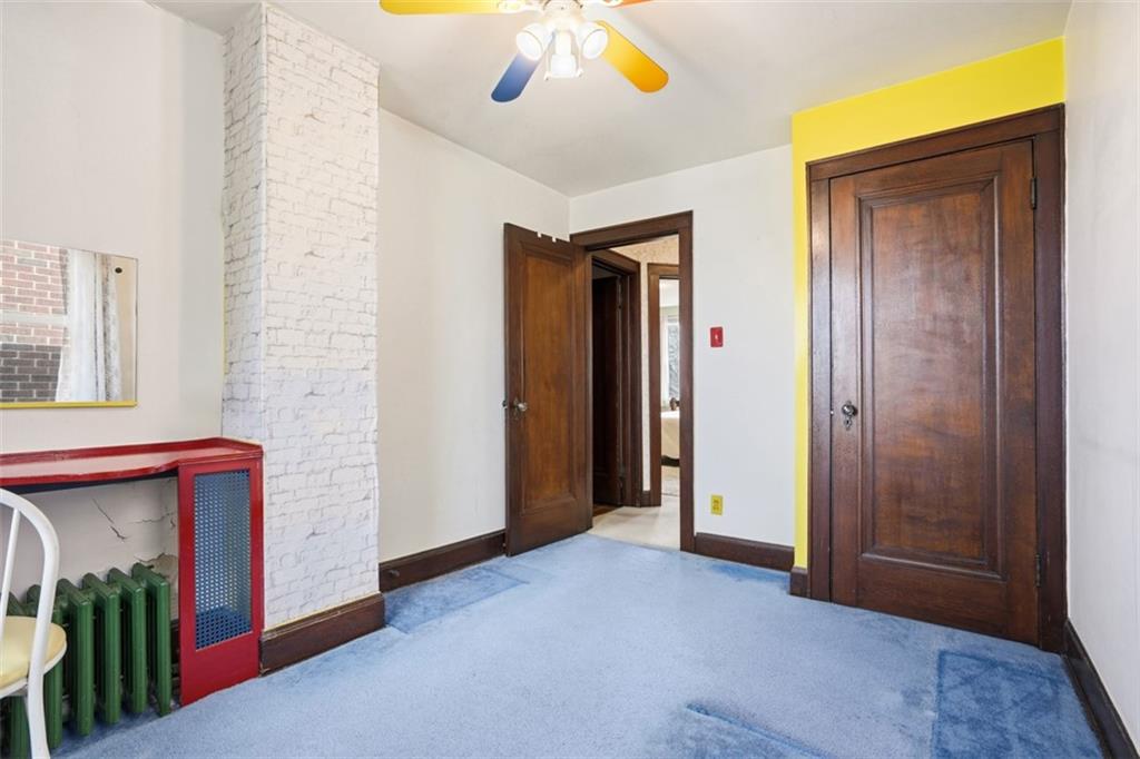 205 Clover Street Pittsburgh, PA 15210 - Photo 25 of 49 an empty room with windows and ceiling fan