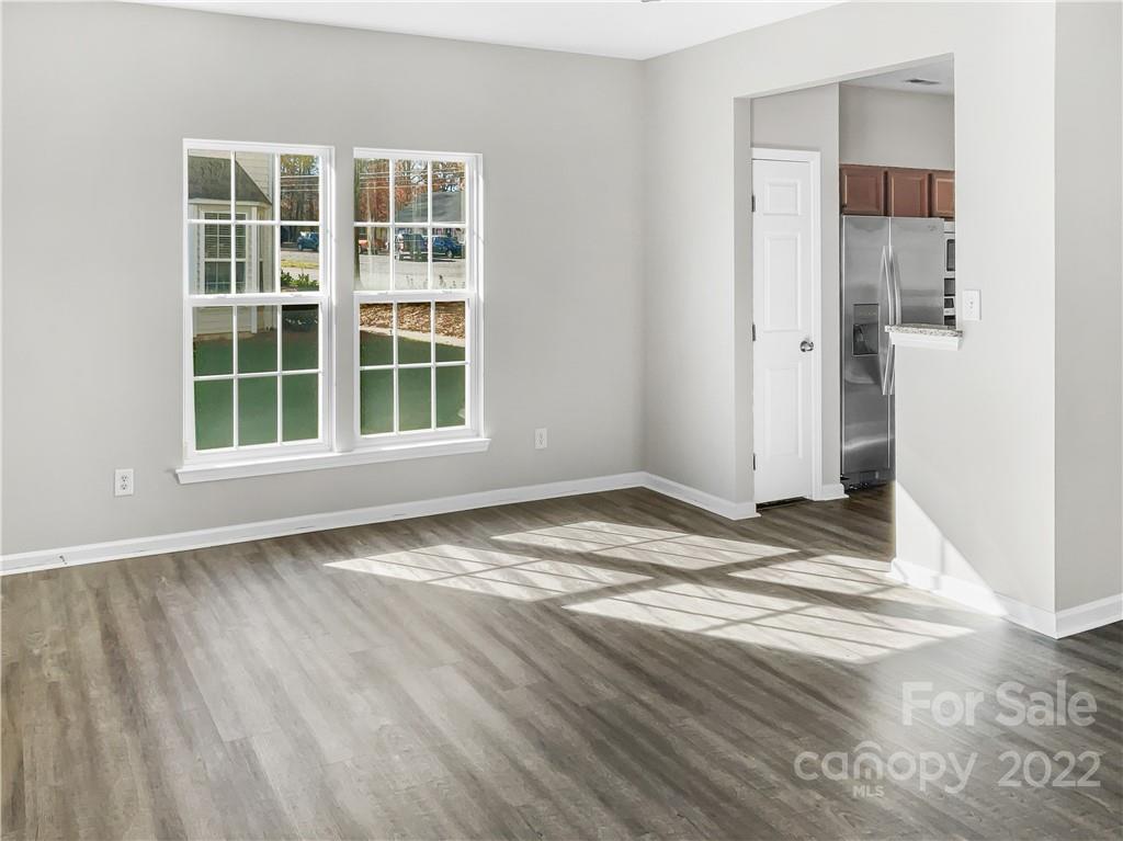 6156 Prosperity Church Road Charlotte, NC 28269 - Photo 12 of 31 a view of empty room with wooden floor and window