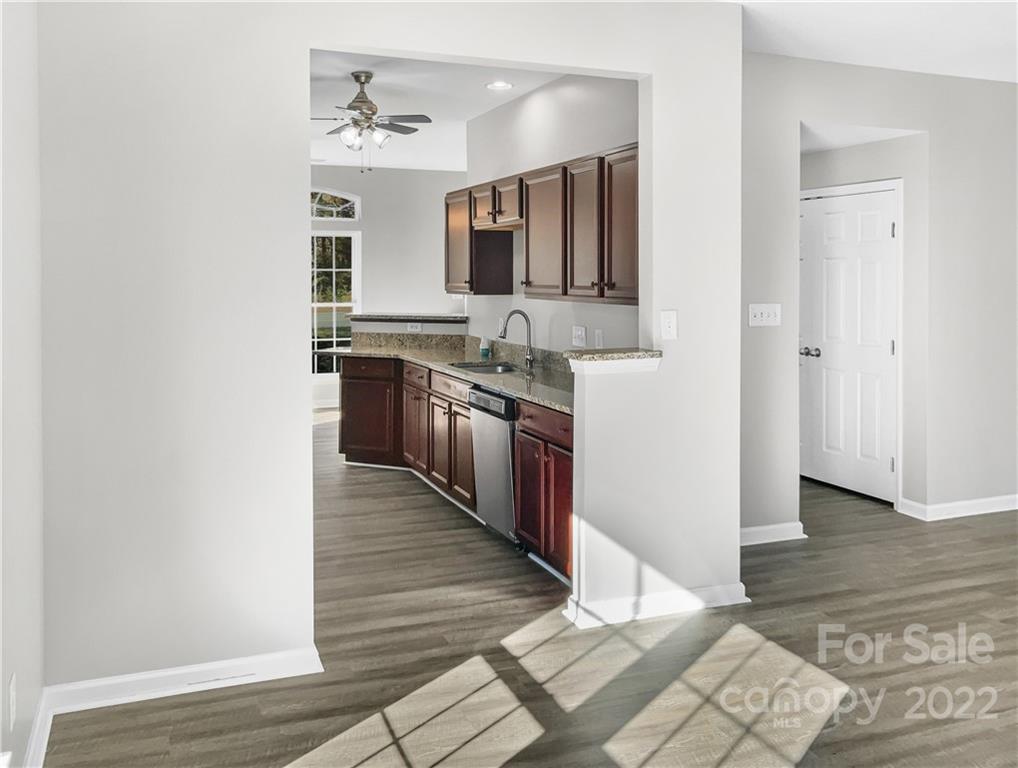 6156 Prosperity Church Road Charlotte, NC 28269 - Photo 14 of 31 a kitchen with stainless steel appliances granite countertop a sink stove and cabinets