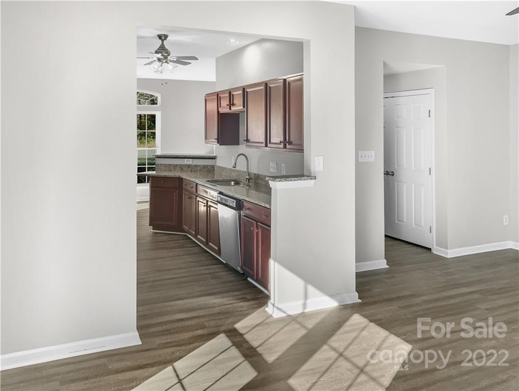 6156 Prosperity Church Road Charlotte, NC 28269 - Photo 15 of 31 a kitchen with stainless steel appliances granite countertop a sink and cabinets