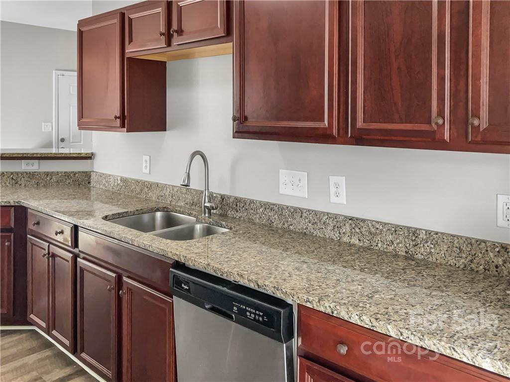 6156 Prosperity Church Road Charlotte, NC 28269 - Photo 16 of 31 a kitchen with granite countertop a sink a stove and cabinets